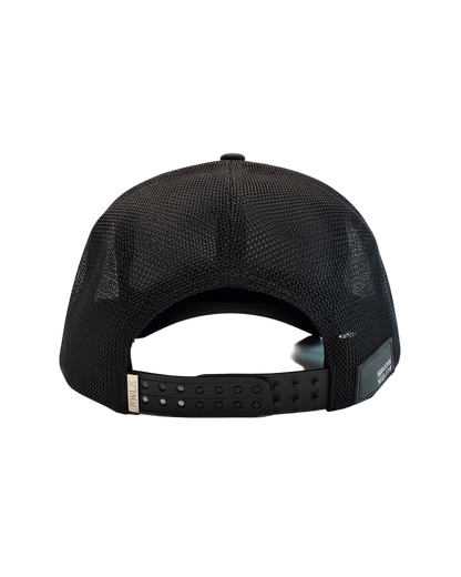Back view of the RWLS Black snapback. Trucker style cap with a black brim. Chrome RWLS engraved metal logo on the left of a dual snap strap. Small Rebellious Wealth leather patch on bottom right side of the hat. Adjustable to fit any head size. rebellious wealth.com