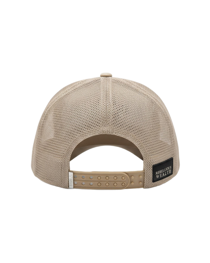 Back view of the RWLS 121, Beige cream color trucker hat. Dual snapback with a chrome engraved RWLS logo on the strap. Mesh side and back panels with a leather Rebellious Wealth brand logo patch on the bottom right. rebelliouswealth.com 