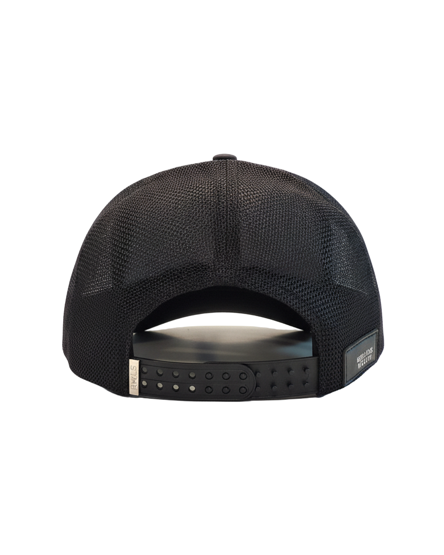 Back view of the Black RWLS trucker snapback hat Signature series. Black mesh side and back panels. Chrome engraved logo on a dual snap strap. Rebellious Wealth leather logo patch sewn on the bottom right. rebelliouswealth.com