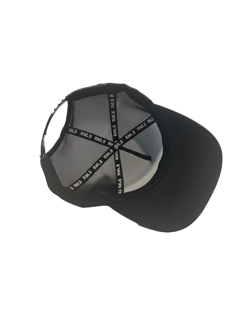 Interior view of the Black Rebellious Wealth trucker snapback hat. Mesh side panels and dual snapback strap. RWLS logos printed along the inseam tape. rebelliouswealth.com