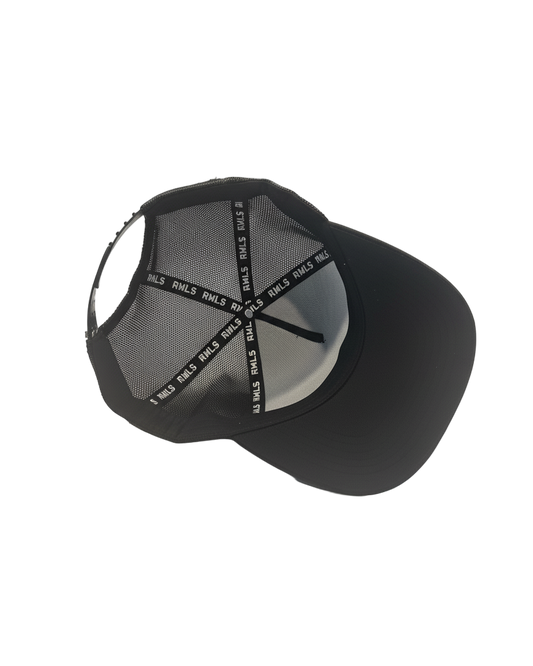 Interior view of the Black Rebellious Wealth trucker snapback hat. Mesh side panels and dual snapback strap. RWLS logos printed along the inseam tape. rebelliouswealth.com