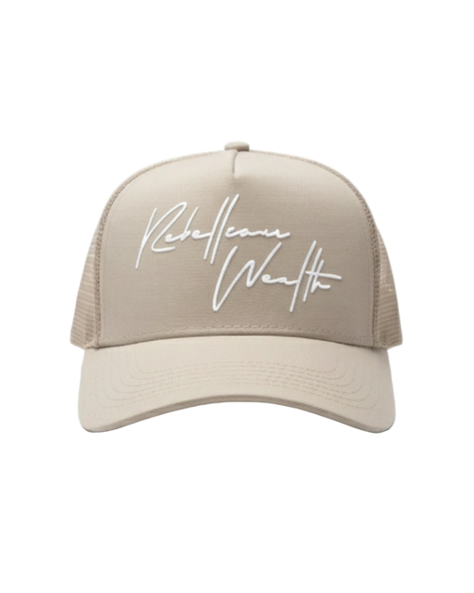 Beige cream color trucker hat with white 'Rebellious Wealth' signature script text logo on the front panel. Mesh side panels. rebelliouswealth.com