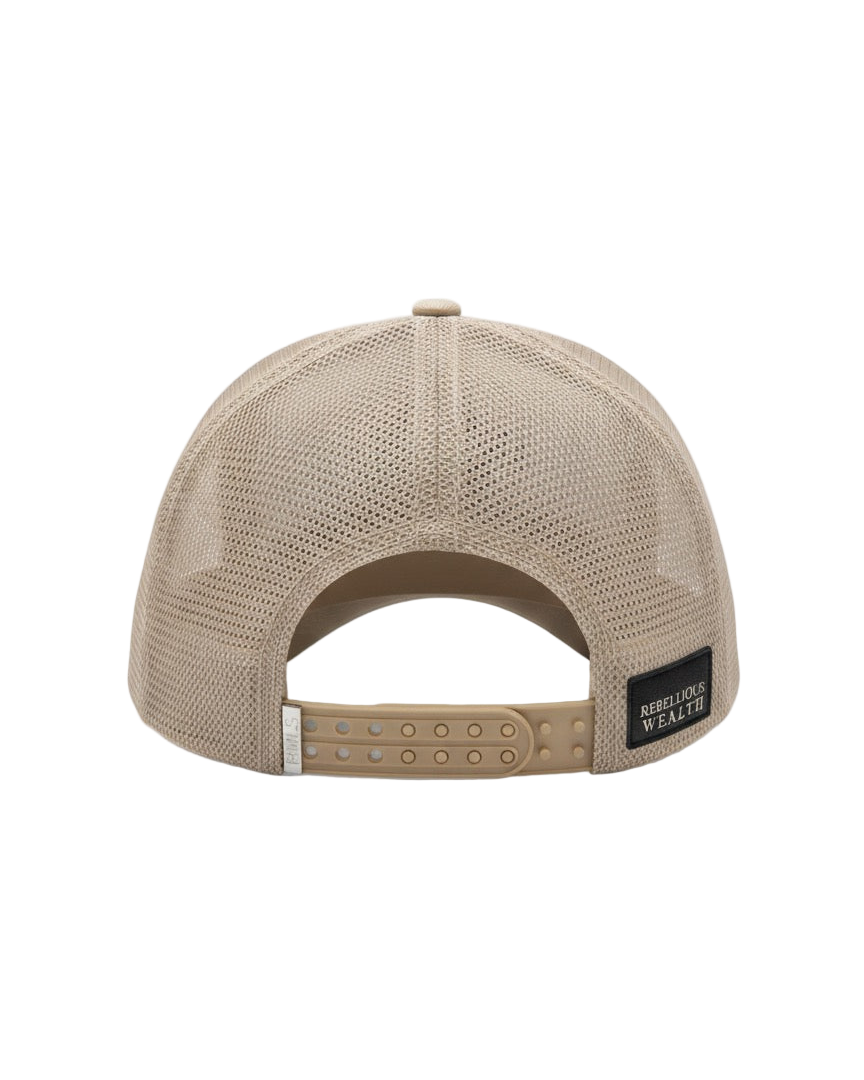 Back view of the RWLS Beige cream color trucker hat. Dual snapback with a chrome engraved RWLS logo on the strap. Mesh side and back panels with a leather Rebellious Wealth brand logo patch on the bottom right. rebelliouswealth.com 